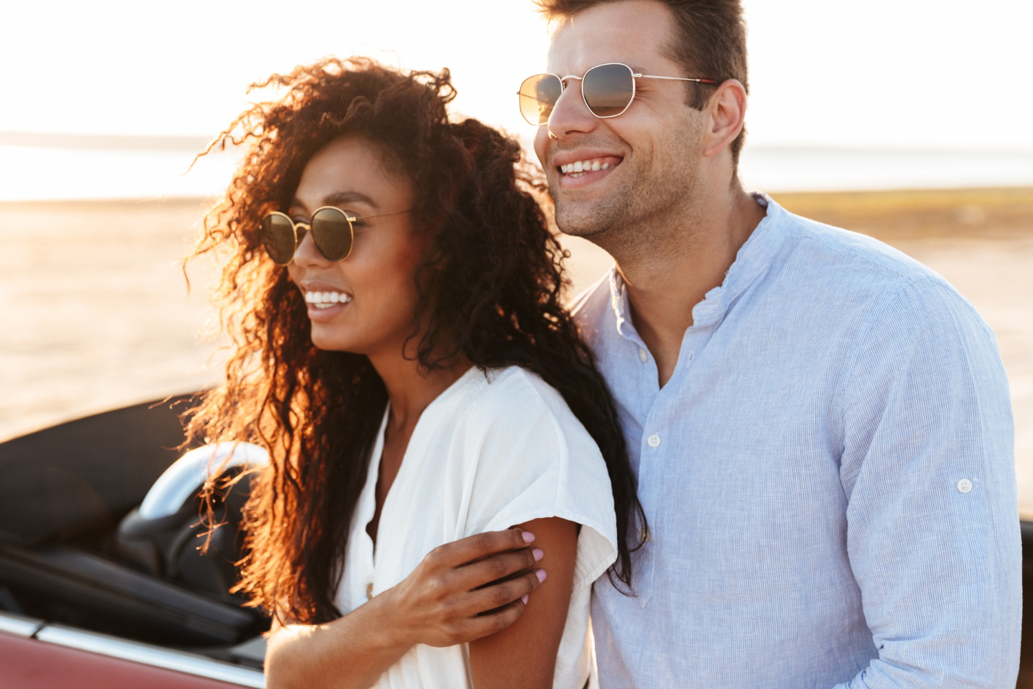 Adult couple smiling together beside the water